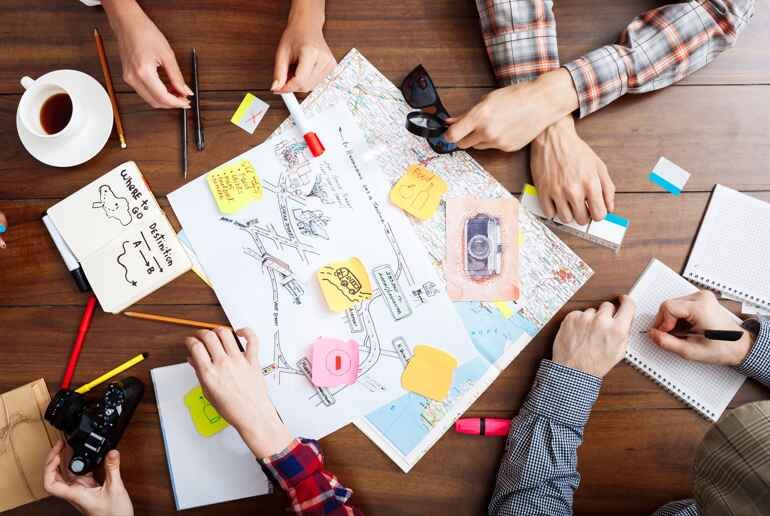 Face-to-face event planning meeting with concept notes and client feedback